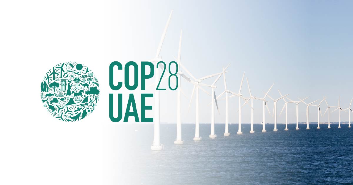 COP28 logo across a backdrop of offshore wind turbines
